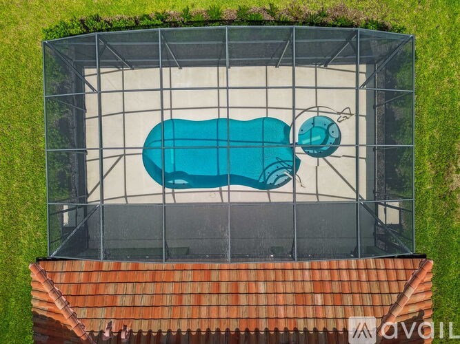 A blue hot tub is surrounded by a metal cage.