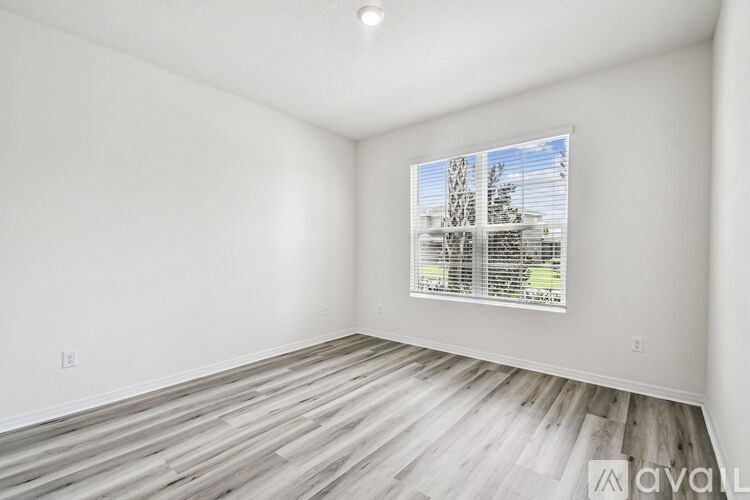 A bathroom with a tub, sink, and mirror.