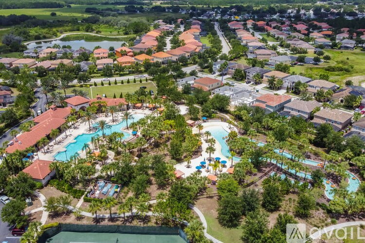 A bird's eye view of a resort with a swimming pool and a water slide.