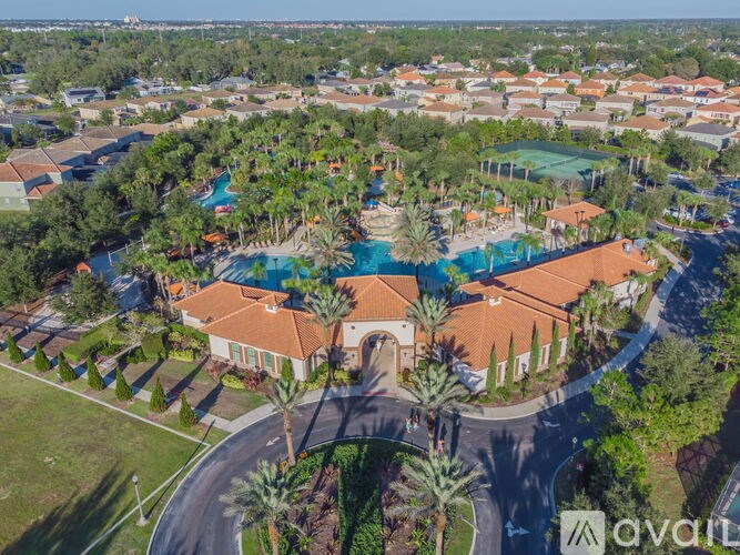 A bird's eye view of a resort with a swimming pool and palm trees.