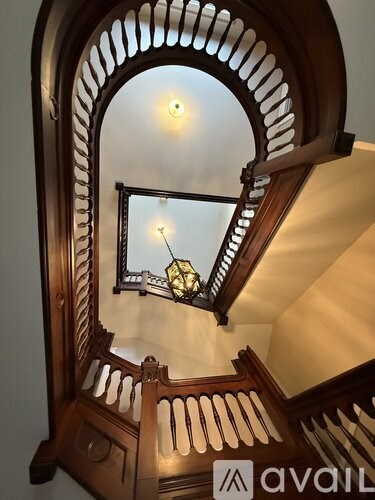 A staircase with a wooden balustrade and a glass balustrade.