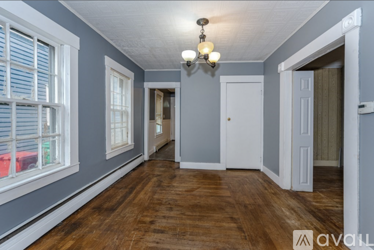 A room with wooden floors and white doors.