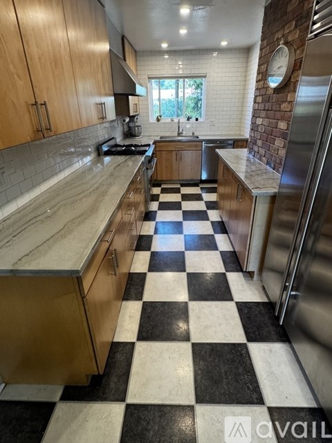 A kitchen with black and white checkered floor.