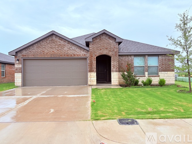 A house with a brick facade and a grey garage door.