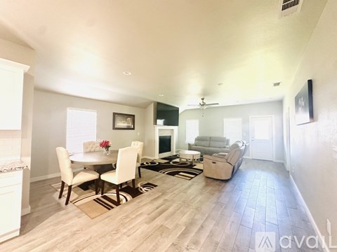 A living room with a dining table and chairs.