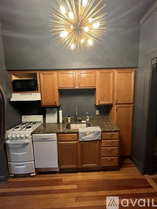 A kitchen with wooden cabinets and a granite countertop.