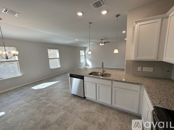 A kitchen with a sink and a window.