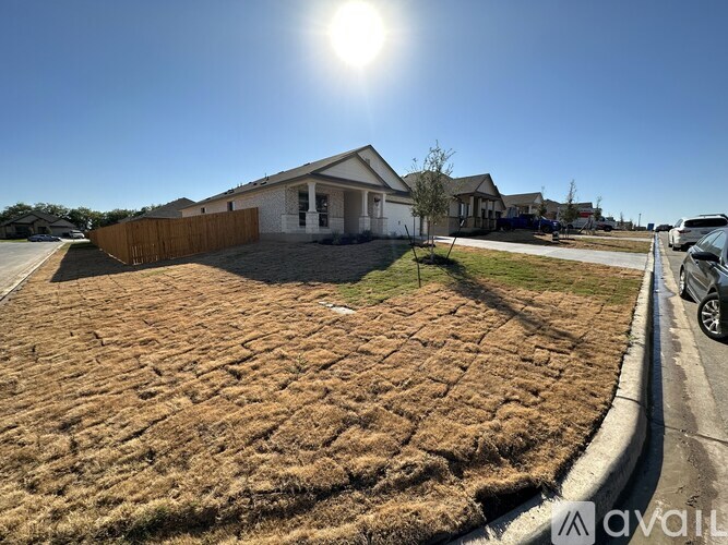 A house with a brown lawn is for sale.