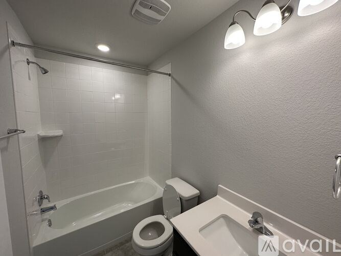 A bathroom with a toilet, sink, and bathtub.