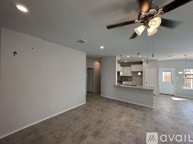 A spacious room with a ceiling fan and a large mirror on the wall.