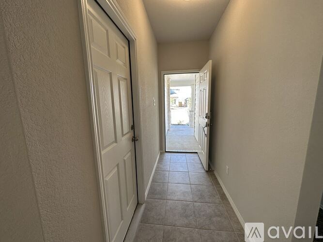 A hallway with a door on the left and another door on the right.