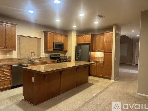 A kitchen with wooden cabinets and a granite countertop.