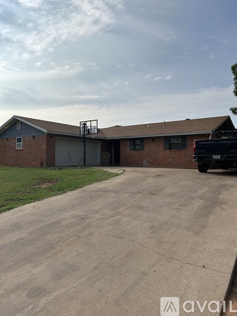 A house with a garage and a truck parked in front.