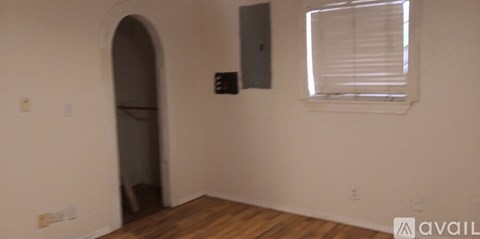 A room with a window and a doorway.