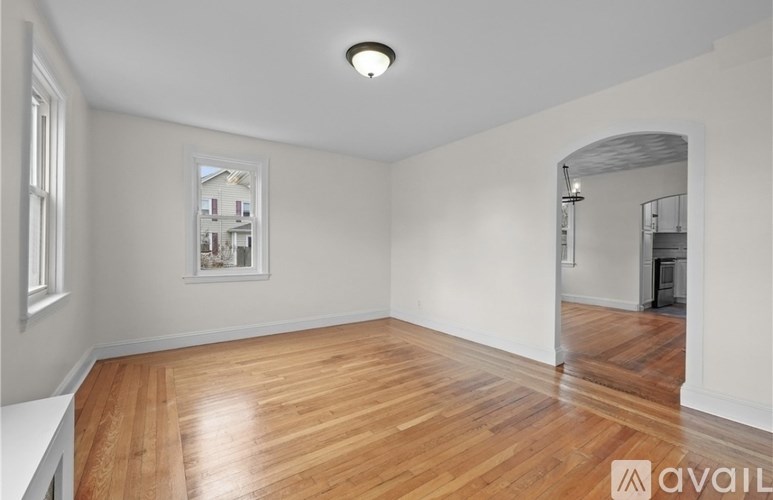 A room with wooden flooring and a picture on the wall.
