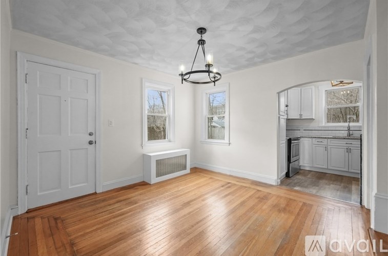 A room with wooden floors and a chandelier.