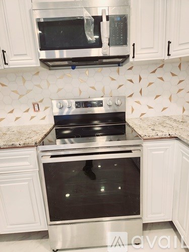 A kitchen with a stove top oven and microwave above it.