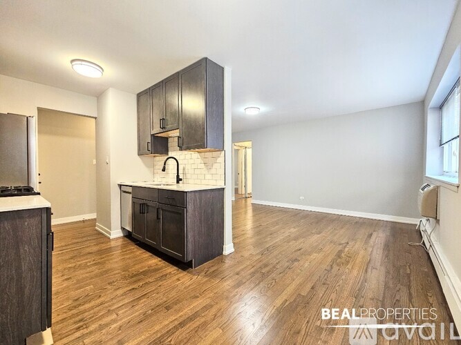 A kitchen with dark wood floors and cabinets.