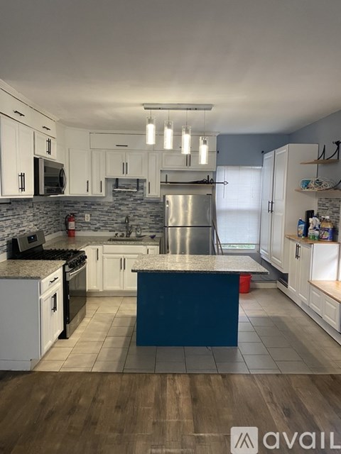 A kitchen with a blue island in the middle.
