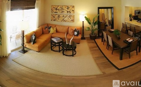 A living room with a brown sofa and a coffee table.