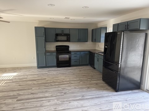 A kitchen with dark wood cabinets and stainless steel appliances.