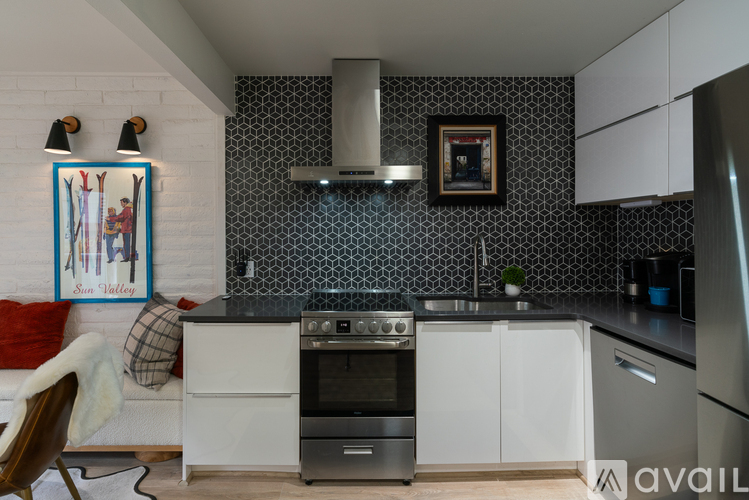 A kitchen with a stove top oven and a fridge.