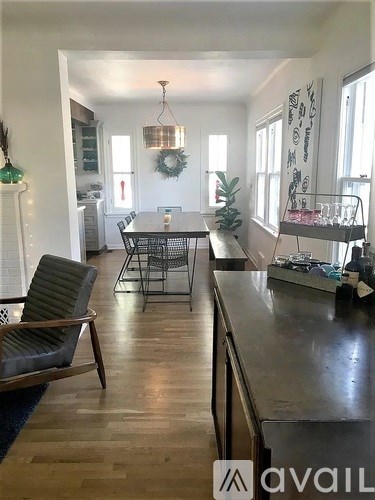 A kitchen with a dining table and chairs.
