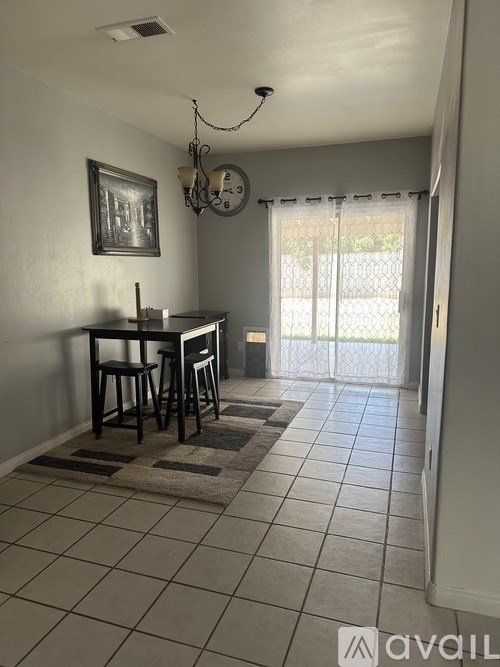 A dining area with a table and chairs.