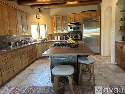 A kitchen with wooden cabinets and a granite countertop.