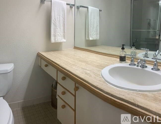 A bathroom with a wooden countertop and a white sink.