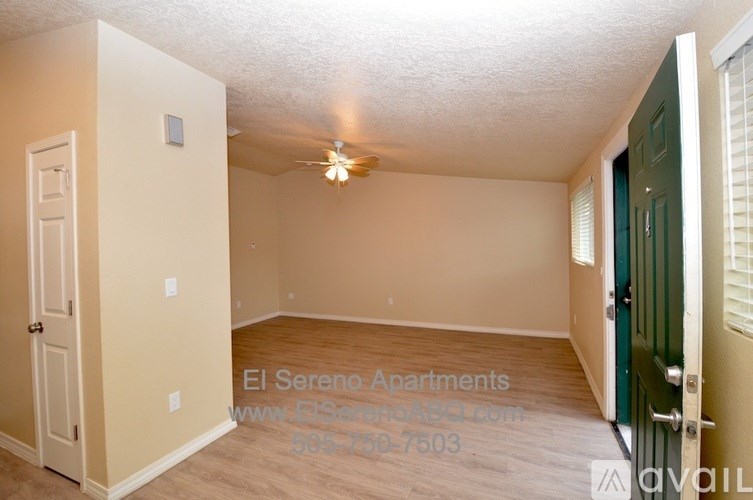 A room with a door on the left and a green door on the right.