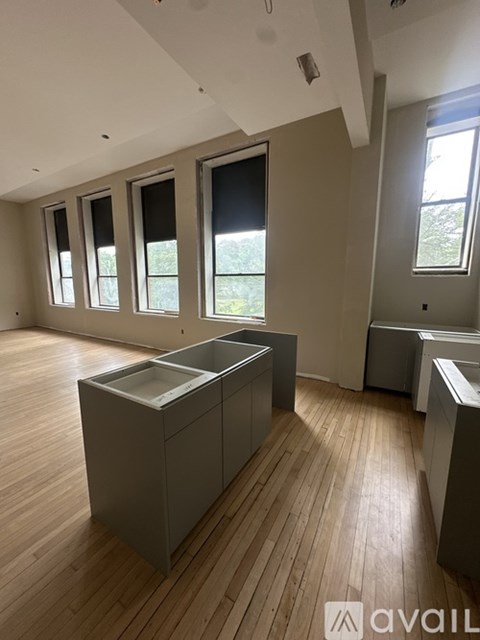 A kitchen with wooden floors and a large island in the middle.