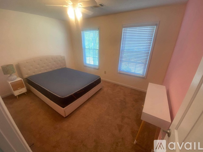 A room with a Christmas tree decoration on the wall and a blue couch.