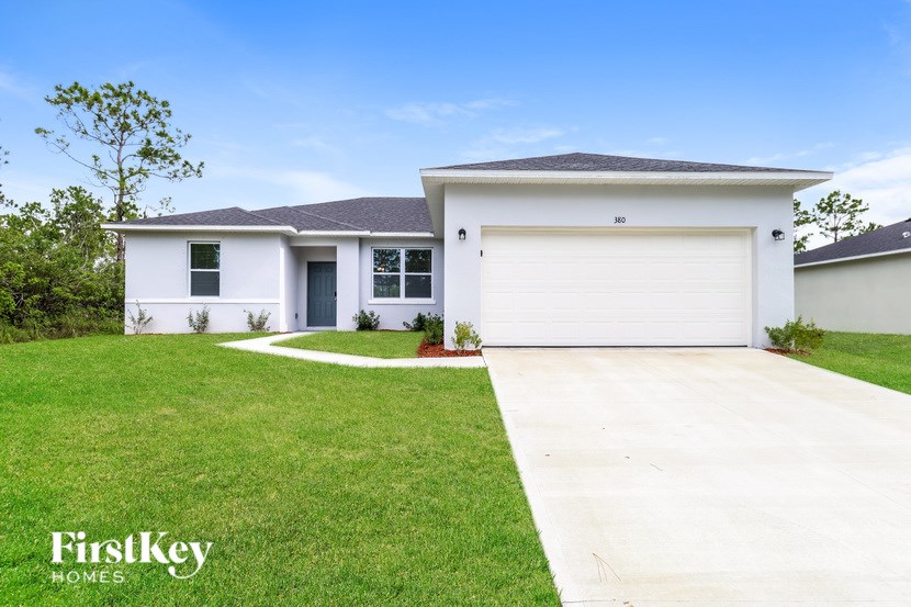A white house with a garage door numbered 302 is for sale by FirstKey Homes.