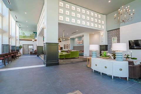 A spacious lobby with a green and white color scheme.