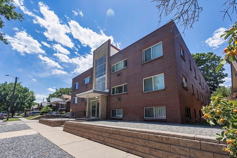 A modern red brick building with a curved section on the right side.