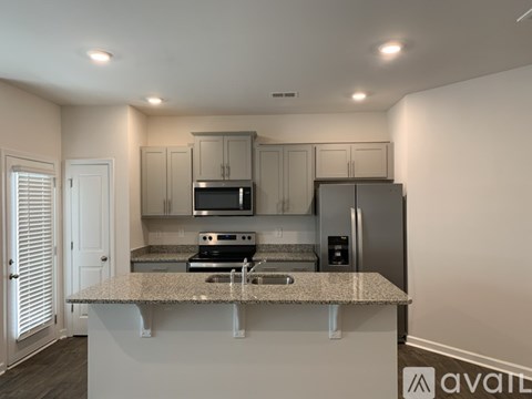 A kitchen with granite countertops and stainless steel appliances.