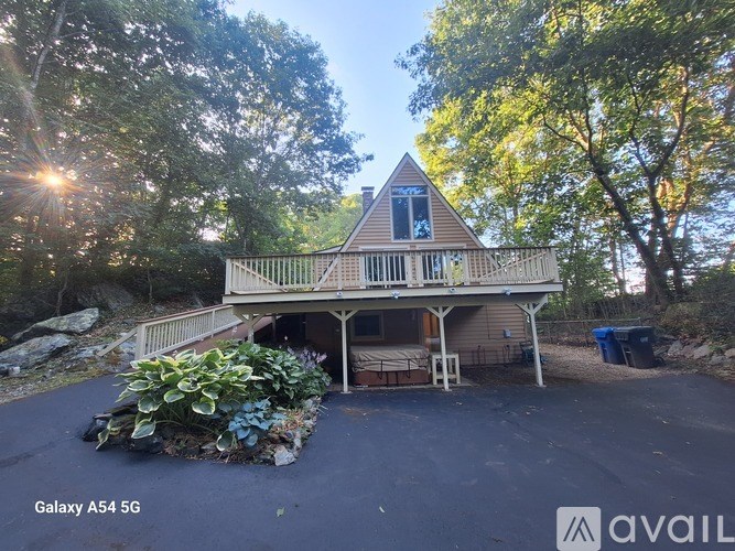 A house with a large front yard and a paved driveway.