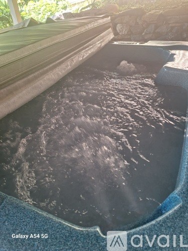 A Galaxy A54 5G phone is displayed in a pool of water.