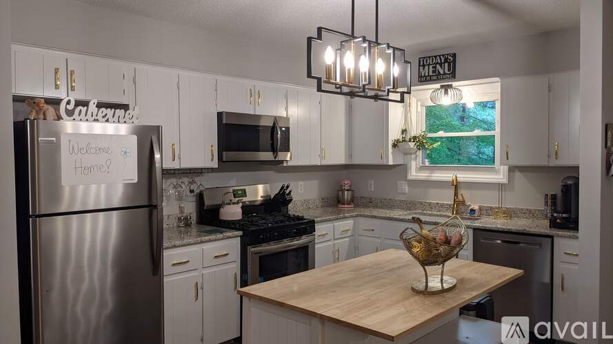 A kitchen with a refrigerator that says "Welcome Home" on it.