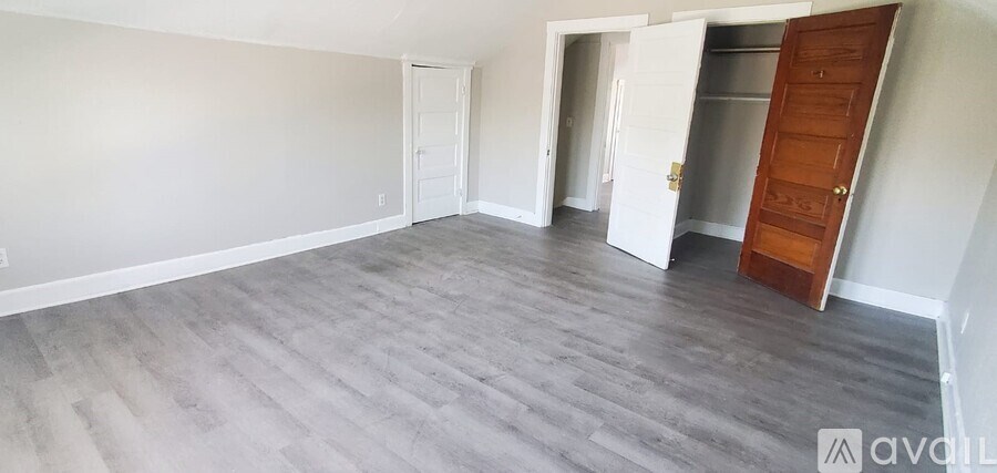 A room with a grey floor and white walls.