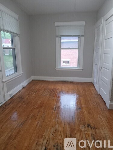 A room with wooden floors and white walls.