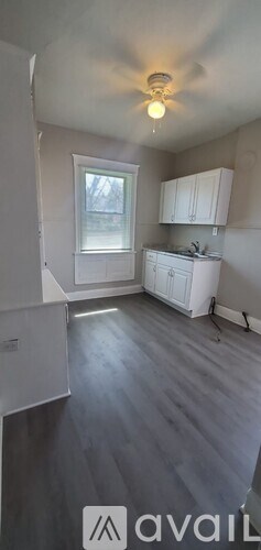 A room with a grey floor and white walls.