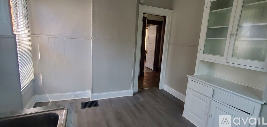 A kitchen with white cabinets and a black sink.