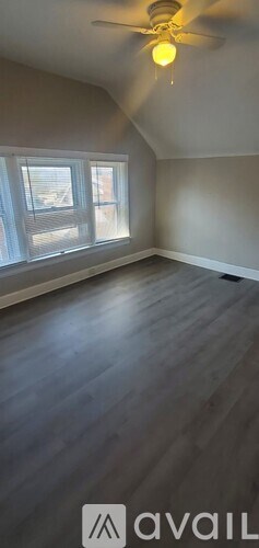 A room with a ceiling fan and a window.