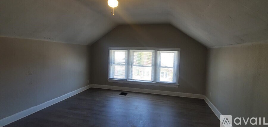 A room with a window and a ceiling light.