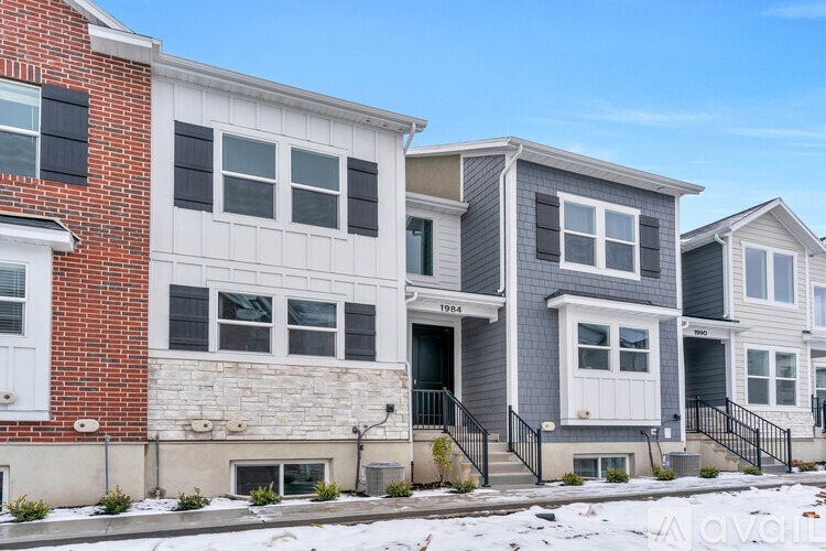 A row of houses with a clear blue sky in the background.