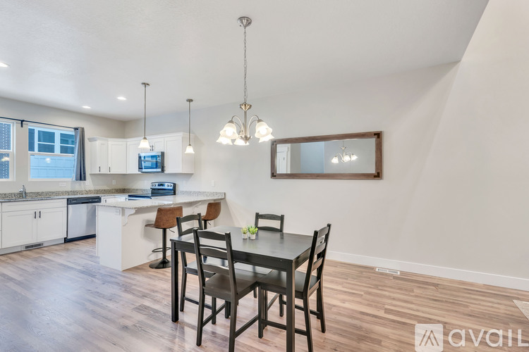 A kitchen with a table and chairs in the middle of the room.
