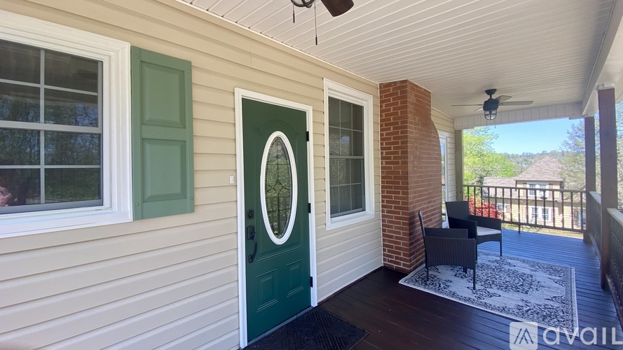 A house with a green door and a fan on the ceiling.