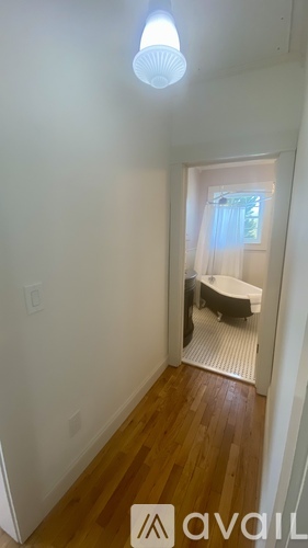 A bedroom with a bed and a window.